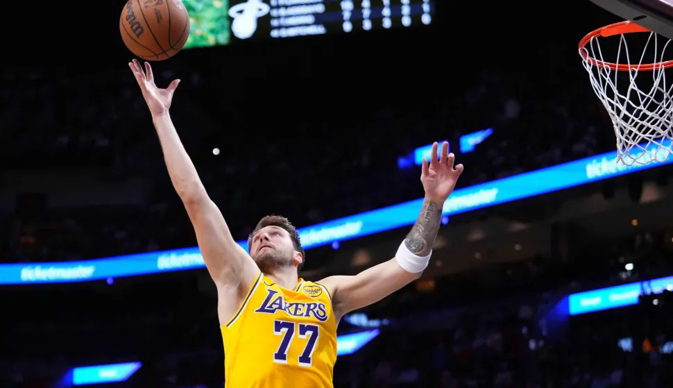 MIAMI, FLORIDA - MARCH 19: Luka Doncic #77 of the Los Angeles Lakers collects a rebound against the Miami Heat during the third quarter at Kaseya Center on March 19, 2026 in Miami, Florida. NOTE TO USER: User expressly acknowledges and agrees that, by downloading and or using this photograph, User is consenting to the terms and conditions of the Getty Images License Agreement. Rich Storry/Getty Images/AFP (Photo by Rich Storry/GETTY IMAGES NORTH AMERICA/Getty Images via AFP)