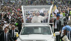 Pope Leo XIV (C) waves to the crowd from the Popemobile as he arrives to lead the Holy Mass at the area in front of Japoma Stadium in Douala on the fifth day of an 11-day apostolic journey to Africa, on April 17, 2026. (Photo by Alberto PIZZOLI/AFP)