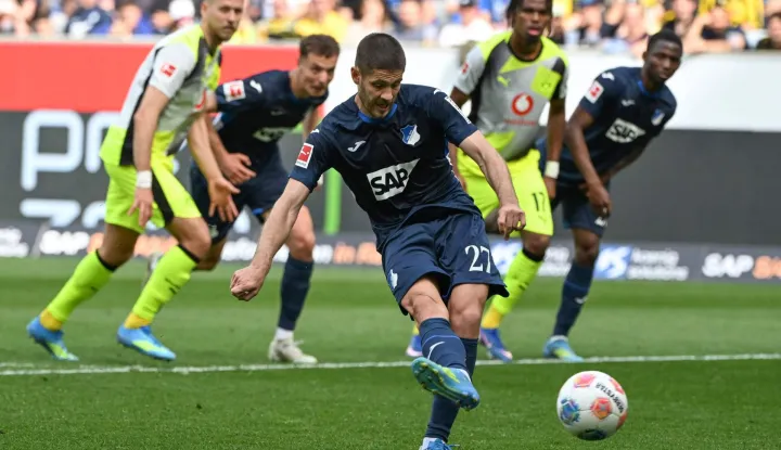 Hoffenheim's Croatian forward #27 Andrej Kramaric scores a penalty during the German first division Bundesliga football match between TSG 1899 Hoffenheim and BVB Borussia Dortmund in Sinsheim, southwestern Germany on April 18, 2026. (Photo by Uli Deck/AFP)/DFL REGULATIONS PROHIBIT ANY USE OF PHOTOGRAPHS AS IMAGE SEQUENCES AND/OR QUASI-VIDEO