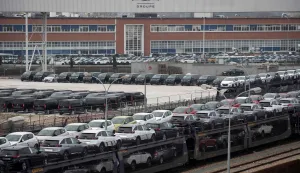 (FILES) Vehicles stand parked in a lot in front of the French automaker PSA Peugeot-Citroen Poissy plant at Poissy, outside Paris on March 28, 2019. Automaker Stellantis will cease automobile production at its historic Poissy plant (Yvelines) after 2028. The site will be converted into a parts manufacturing and vehicle dismantling center, retaining 1,000 of the current 2,000 jobs, the group announced on April 16, 2026. (Photo by Thomas SAMSON/AFP)
