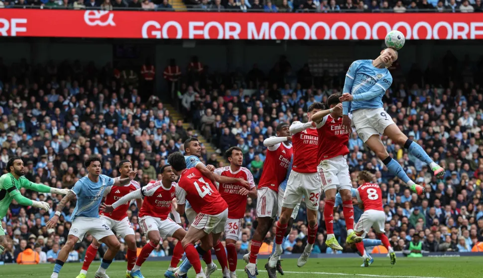 Manchester City's Norwegian striker #09 Erling Haaland (R) heads the ball in front of goal during the English Premier League football match between Manchester City and Arsenal at the Etihad Stadium in Manchester, north west England, on April 19, 2026. (Photo by Darren Staples/AFP)/RESTRICTED TO EDITORIAL USE. No use with unauthorized audio, video, data, fixture lists, club/league logos or 'live' services. Online in-match use limited to 120 images. An additional 40 images may be used in extra time. No video emulation. Social media in-match use limited to 120 images. An additional 40 images may be used in extra time. No use in betting publications, games or single club/league/player publications./