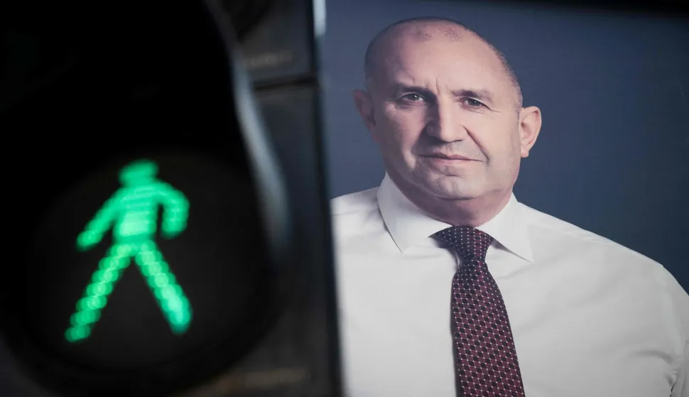 An electoral billboard of Progressive Bulgaria coalition leader and former president Rumen Radev is pictured next to a traffic light in Sofia on April 17, 2026. Bulgaria will hold its eighth general election in five years on April 19, 2026, with ex-president Rumen Radev's new grouping tipped to win a ballot many hope will end chronic instability. (Photo by Nikolay DOYCHINOV/AFP)