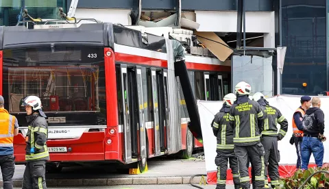 Firefighters and rescue personnel stand next to a trolleybus that crashed into a supermarket on April 20, 2026 in Salzburg, Austria, killing one person and injuring seven peaple, two of them severely. (Photo by various sources/AFP)/Austria OUT