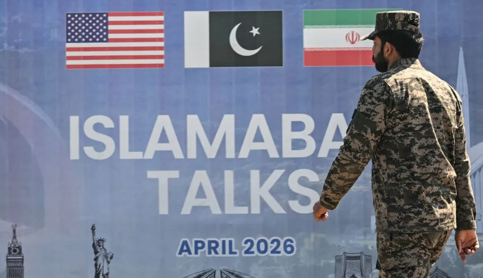 A Pakistani Ranger walks past a billboard for the US-Iran peace talks in Islamabad on April 12, 2026. Iran and the United States failed to reach an agreement to end the war in the Middle East, US Vice President JD Vance said on April 12 after marathon talks in Islamabad, adding that he was leaving negotiations after giving Tehran the "final and best offer". (Photo by Farooq NAEEM/AFP)