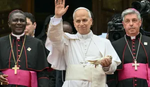 Pope Leo XIV (C) holds a white dove before releasing it after he met with the community of Bamenda at Saint Joseph's Cathedral in Bamenda, on the fourth day of an 11-day apostolic journey to Africa, on April 16, 2026. (Photo by Alberto PIZZOLI/AFP)