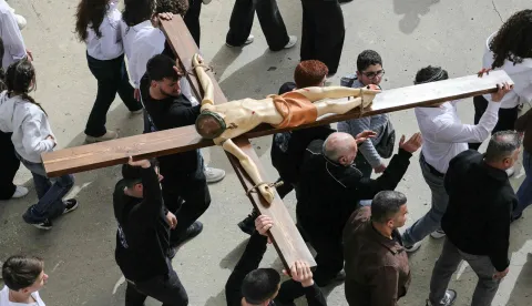 Lebanese Maronite Christians carry a life-size crucifix as they celebrate Good Friday in the southern border village of Qlayaa on April 3, 2026, amid the ongoing Middle East war. Lebanon was drawn into the Middle East war on March 2 when the Tehran-backed Hezbollah launched rockets at Israel to avenge the US-Israeli attack that killed Iran's supreme leader. Israel has responded with massive strikes across Lebanon as well as the ground operation. (Photo by AFP)
