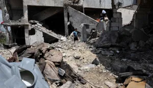 A young boy walks amid the rubble of a building destroyed in an Israeli strike in the southern Lebanese village of Kfar Sir on April 21, 2026. Israeli defence minister said on April 21 that his country's campaign in Lebanon relied on both military and diplomatic pressure to disarm Iran-allied Hezbollah. Though a truce between Israel and Lebanon took effect on April 17, Israeli troops are still present and actively fighting Hezbollah militants in Lebanon's south. (Photo by Anwar AMRO/AFP)