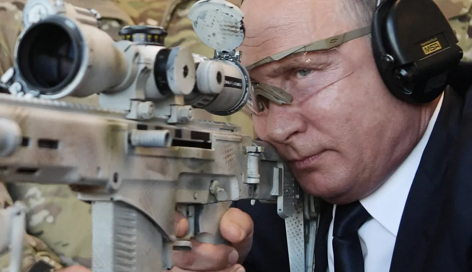 (FILES) In this pool photograph distributed by the Russian state agency Sputnik, Russia's President Vladimir Putin looks through the scope as he shoots a Chukavin sniper rifle (SVC-380) during a visit to the military Patriot Park in Kubinka, outside Moscow on September 19, 2018. Vladimir Putin's four-year-long invasion of Ukraine is the culmination of a quarter century spent tightening his grip on power, crushing opponents and trying to expand Russia's influence - and borders. (Photo by Alexey NIKOLSKY/POOL/AFP)