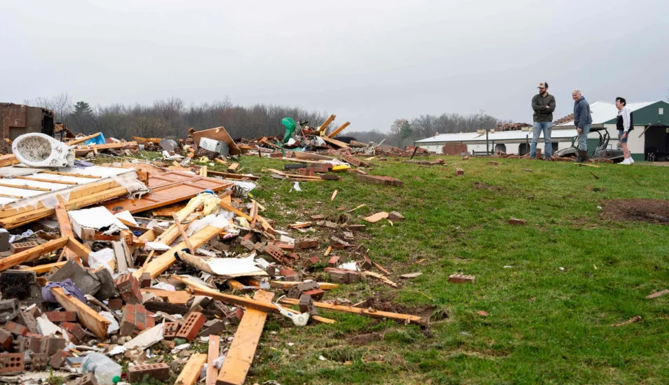 UNION CENTER, WISCONSIN - APRIL 15: Neighbors survey the damage to a home after a tornado on Tuesday along Raese Road on April 15, 2026 in Union Center, Wisconsin. The National Weather Service is tracking the tornado's path as severe weather threats remain from the southern Plains to the Upper Midwest and Great Lakes regions. Kayla Wolf/Getty Images/AFP (Photo by Kayla Wolf/GETTY IMAGES NORTH AMERICA/Getty Images via AFP)