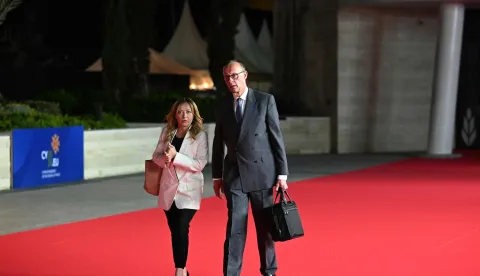 Italy's Prime Minister Giorgia Meloni (L) and Germany's Chancellor Friedrich Merz leave after attending the working dinner of an informal meeting of the European Council, in Ayia Napa on April 24, 2026. (Photo by NICOLAS TUCAT/AFP)