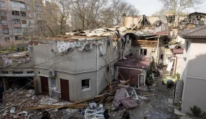CORRECTION/Local residents attend outside three-storey residential building destroyed as a result of Russian drones attack in Odesa on April 24, 2026, amid Russian invasion in Ukraine. Two people were killed and fifteen wounded following Rissian drones attack in Black Sea Ukrainian city of Odesa on April 23, 2026. (Photo by Oleksandr GIMANOV/AFP)/?The erroneous mention[s] appearing in the metadata of this photo by Oleksandr GIMANOV has been modified in AFP systems in the following manner: [April 24] instead of [April 23]. Please immediately remove the erroneous mention[s] from all your online services and delete it (them) from your servers. If you have been authorized by AFP to distribute it (them) to third parties, please ensure that the same actions are carried out by them. Failure to promptly comply with these instructions will entail liability on your part for any continued or post notification usage. Therefore we thank you very much for all your attention and prompt action. We are sorry for the inconvenience this notification may cause and remain at your disposal for any further information you may require.?