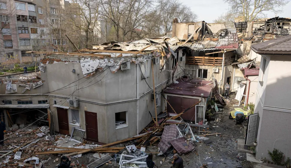 CORRECTION/Local residents attend outside three-storey residential building destroyed as a result of Russian drones attack in Odesa on April 24, 2026, amid Russian invasion in Ukraine. Two people were killed and fifteen wounded following Rissian drones attack in Black Sea Ukrainian city of Odesa on April 23, 2026. (Photo by Oleksandr GIMANOV/AFP)/?The erroneous mention[s] appearing in the metadata of this photo by Oleksandr GIMANOV has been modified in AFP systems in the following manner: [April 24] instead of [April 23]. Please immediately remove the erroneous mention[s] from all your online services and delete it (them) from your servers. If you have been authorized by AFP to distribute it (them) to third parties, please ensure that the same actions are carried out by them. Failure to promptly comply with these instructions will entail liability on your part for any continued or post notification usage. Therefore we thank you very much for all your attention and prompt action. We are sorry for the inconvenience this notification may cause and remain at your disposal for any further information you may require.?