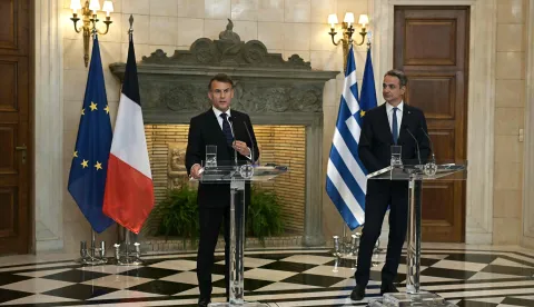 France's President Emmanuel Macron (L) and Greece's Prime Minister Kyriakos Mitsotakis attend a press conference after signing bilateral agreements at Maximos mansion, in Athens, on April 25, 2026. The two leaders signed a text titled ?Enhanced Comprehensive Strategic Partnership between Greece and France? and signed the renewal of the Strategic Relationship Agreement for cooperation in security and defense. (Photo by Aris MESSINIS/AFP)