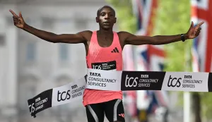 TOPSHOT - Kenya's Sabastian Sawe crosses the line to win the men's race in a new world record time at the 2026 London Marathon in central London on April 26, 2026. Kenya's Sabastian Sawe broke the two-hour mark for the first time in history on Sunday in winning the London Marathon. (Photo by JUSTIN TALLIS/AFP)/?Restricted to editorial use - sponsorship of content subject to LMEL agreement?.