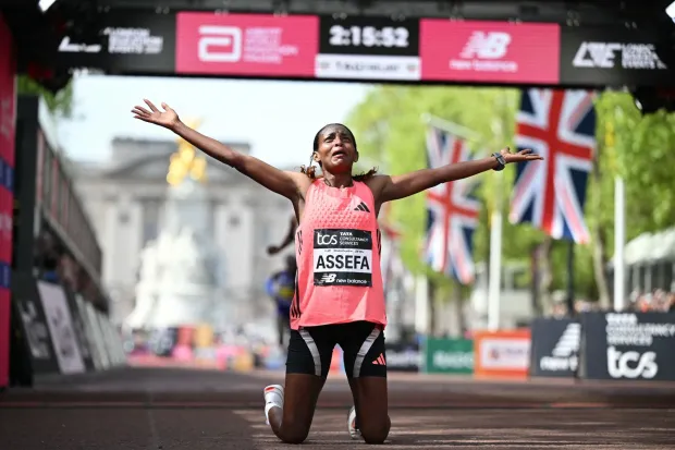 TOPSHOT - Ethiopia's Tigst Assefa reacts after crossing the line to win the women's race in a new women's only world record at the 2026 London Marathon in central London on April 26, 2026. (Photo by JUSTIN TALLIS/AFP)/?Restricted to editorial use - sponsorship of content subject to LMEL agreement?.