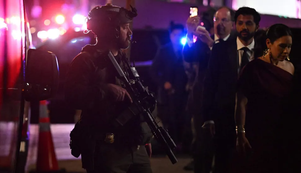TOPSHOT - Armed commandos stand by as special guests are evacuated from the back of the Washington Hilton after shots were reportedly fired during the White House Correspondents' dinner at the Washington Hilton in Washington, DC, on April 25, 2026. Shots were allegedly fired as US President Donald Trump attended a press dinner in Washington on Saturday night, witnesses and AFP reporters said as loud bangs were heard at the hotel venue. (Photo by ROBERTO SCHMIDT/AFP)