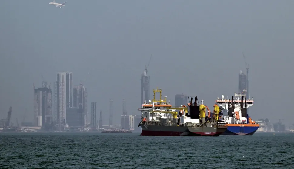 TOPSHOT - Commercial vessels are pictured offshore in Dubai on March 11, 2026. New attacks hit three commercial ships in the Gulf on March 11, with one of the vessels in flames as Iran pressed its campaign against its oil-exporting neighbours, threatening shipping in the Strait of Hormuz and plunging the global energy economy into crisis. (Photo by AFP)/Attention editors: AFP covers the war in the Middle East through its extensive regional network, including bureaus in Tehran, Jerusalem and several neighboring countries.Since the start of the conflict, journalists have been working under increasingly restrictive conditions. Authorities in several countries have limited reporters? movements, photo and live video coverage from sensitive locations. Some governments and armed groups have banned images of missile or drone strikes and other security-related sites./