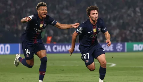 TOPSHOT - Paris Saint-Germain's Portuguese midfielder #87 Joao Neves (R) celebrates with Paris Saint-Germain's French midfielder #14 Desire Doue after scoring his team second goal during the UEFA Champions League semi-final first leg football match between Paris Saint-Germain (PSG) and Bayern Munich at the Parc des Princes in Paris on April 28, 2026. (Photo by FRANCK FIFE/AFP)