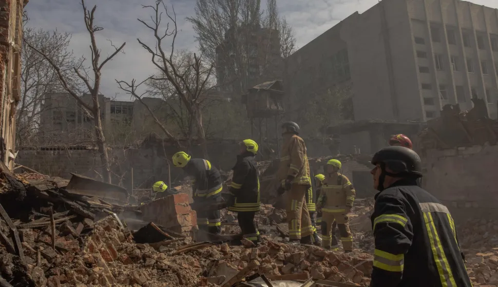 Ukrainian rescuers work at the site of heavily damaged buildings following a Russian air attack in Dnipro, on April 16, 2026, amid the Russian invasion of Ukraine. Massive Russian strikes on Ukraine left at least 19 people dead overnight from April 15 to April 16, particularly in Kyiv and Odesa, Ukrainian authorities said on April 16, 2026, describing these attacks as among the deadliest in recent weeks. (Photo by Roman PILIPEY/AFP)