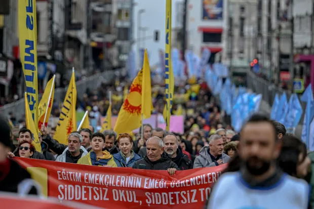 Protesters hold a banner that reads "No violence at school, no violence in the society" during a May Day (Labour Day) rally, marking International Workers' Day, in the Kadikoy district of Istanbul, on May 1, 2026. At least 370 people were arrested on May 1, 2026 during demonstrations in Istanbul curbed by a heavy police deployment, a lawyers' association present at the rallies said. (Photo by Ozan KOSE/AFP)