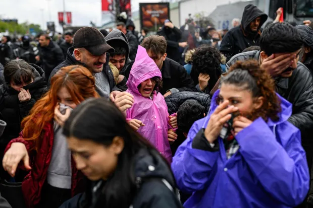 Protestors react as Turkish police use pepper spray to disperse demonstrators during a May Day (Labour Day) rally, marking international Workers' Day, in Besiktas, a district of Istanbul, on May 1, 2026. Turkish police fired tear gas and arrested dozens of people holding May Day demonstrations in Istanbul, AFP journalists said. Two groups were specially singled out in the city's European side after signalling their intention to march to Taksim square -- the scene of several anti-government protests in the past -- which was sealed off overnight by police. (Photo by Yasin AKGUL/AFP)