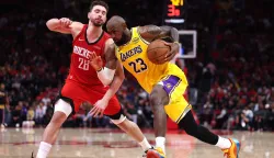 HOUSTON, TEXAS - MAY 01: LeBron James #23 of the Los Angeles Lakers drives to the basket against Alperen Sengun #28 of the Houston Rockets during the fourth quarter in Game Six of the First Round of the NBA Western Conference Playoffs at Toyota Center on May 01, 2026 in Houston, Texas. NOTE TO USER: User expressly acknowledges and agrees that, by downloading and or using this photograph, User is consenting to the terms and conditions of the Getty Images License Agreement. Kenneth Richmond/Getty Images/AFP (Photo by Kenneth Richmond/GETTY IMAGES NORTH AMERICA/Getty Images via AFP)