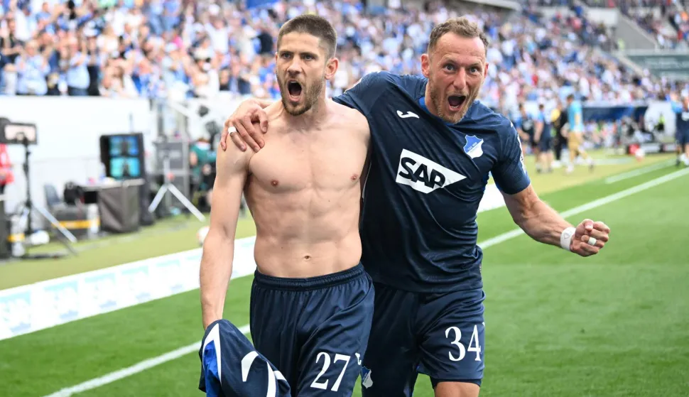 Hoffenheim's Croatian forward #27 Andrej Kramaric celebrates his 3-1 with Hoffenheim's Czech midfielder #34 Vladimir Coufal during the German first division Bundesliga football match between TSG Hoffenheim and VfB Stuttgart in Sinsheim, on May 2, 2026. (Photo by THOMAS KIENZLE/AFP)/DFL REGULATIONS PROHIBIT ANY USE OF PHOTOGRAPHS AS IMAGE SEQUENCES AND/OR QUASI-VIDEO