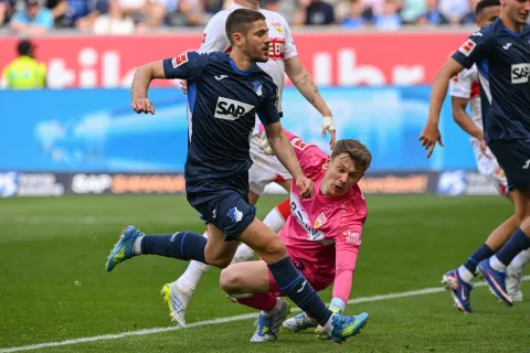 Hoffenheim's Croatian forward #27 Andrej Kramaric (L) scores the 3-1 past Stuttgart's German goalkeeper #33 Alexander Nuebel during the German first division Bundesliga football match between TSG Hoffenheim and VfB Stuttgart in Sinsheim, on May 2, 2026. (Photo by THOMAS KIENZLE/AFP)/DFL REGULATIONS PROHIBIT ANY USE OF PHOTOGRAPHS AS IMAGE SEQUENCES AND/OR QUASI-VIDEO