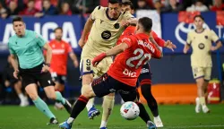 Barcelona's Polish forward #09 Robert Lewandowski is challenged by Osasuna's Spanish midfielder #20 Javi Galan during the Spanish league football match between CA Osasuna and FC Barcelona at El Sadar Stadium in Pamplona on May 2, 2026. (Photo by ANDER GILLENEA/AFP)