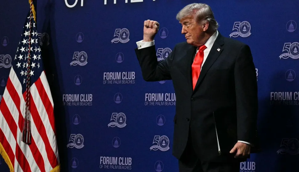 US President Donald Trump makes a fist at The Forum Club of the Palm Beaches Dinner at the Raymond F. Kravis Center for the Performing Arts in West Palm Beach, Florida on May 1, 2026. (Photo by Jim WATSON/AFP)