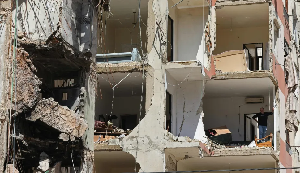 This photograph taken during a media tour organised by the Hezbollah's media office shows a resident inspecting the destructioin at his apartment in Beirut's southern suburbs on May 6, 2026. Israel and Hezbollah have been trading accusations of violating the ceasefire agreement in force since April 17. Hezbollah has claimed responsibility for several operations targeting Israeli forces in southern Lebanon, as well as attacks on northern Israel. (Photo by Anwar AMRO/AFP)