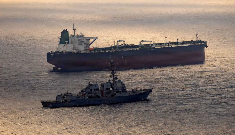 This US Navy handout photo released on May 8, 2026 by US Central Command Public Affairs, shows the Arleigh Burke-class guided-missile destroyer USS Rafael Peralta (DDG 115) implementing a maritime blockade against the Iran-flagged crude oil tanker vessel Herby while the latter was attempting to sail toward an Iranian port, on April 24, 2026. The war launched by the US and Israel in late February saw Iran respond with attacks across the Middle East and maintain a stranglehold on the Strait of Hormuz, choking off major flows of oil, gas, and fertilizer to the world economy, while the US has imposed a counter-blockade on Iranian ports. (Photo by US NAVY/AFP)/RESTRICTED TO EDITORIAL USE - MANDATORY CREDIT "AFP PHOTO/US NAVY/NAVCENT PUBLIC AFFAIRS" - HANDOUT - NO MARKETING NO ADVERTISING CAMPAIGNS - DISTRIBUTED AS A SERVICE TO CLIENTS