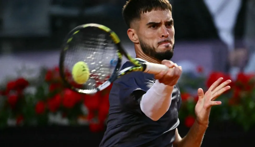 Croatia's Dino Prizmic plays a backhand return to Serbia's Novak Djokovic during their men's singles match of the WTA Rome Open tennis tournament at the Foro Italico in Rome on May 8, 2026. (Photo by Filippo MONTEFORTE/AFP)