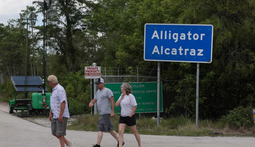 OCHOPEE, FLORIDA - APRIL 22: People walk near the front entrance to the immigration detention center in the Florida Everglades known as ?Alligator Alcatraz" on April 22, 2026, in Ochopee, Florida. A federal appeals court overturned an injunction by a district court judge requiring officials to dismantle ?Alligator Alcatraz? in response to a lawsuit filed by environmental groups. Joe Raedle/Getty Images/AFP (Photo by JOE RAEDLE/GETTY IMAGES NORTH AMERICA/Getty Images via AFP)