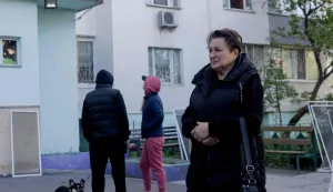 A local resident reacts near a residential building partially destroyed following Russian drone and missile strikes in Kyiv on May 14, 2026, amid the Russian invasion of Ukraine. Russia launched more than 670 drones and 56 missiles at Ukraine overnight, Ukraine's President announced on May 14, 2026. (Photo by Tetiana DZHAFAROVA/AFP)