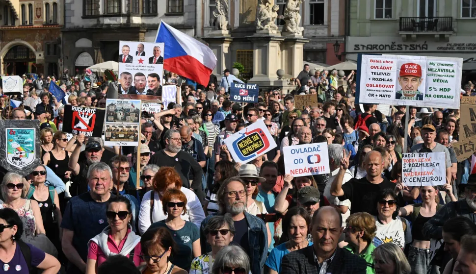 Several hundred people holding placards gather for a protest march to express support for public service media on April 22, 2026, in Prague, Czech Republic. Placard reads "Czech prime Minister Andrej Babis wants to control the media" (Photo by Michal Cizek/AFP)