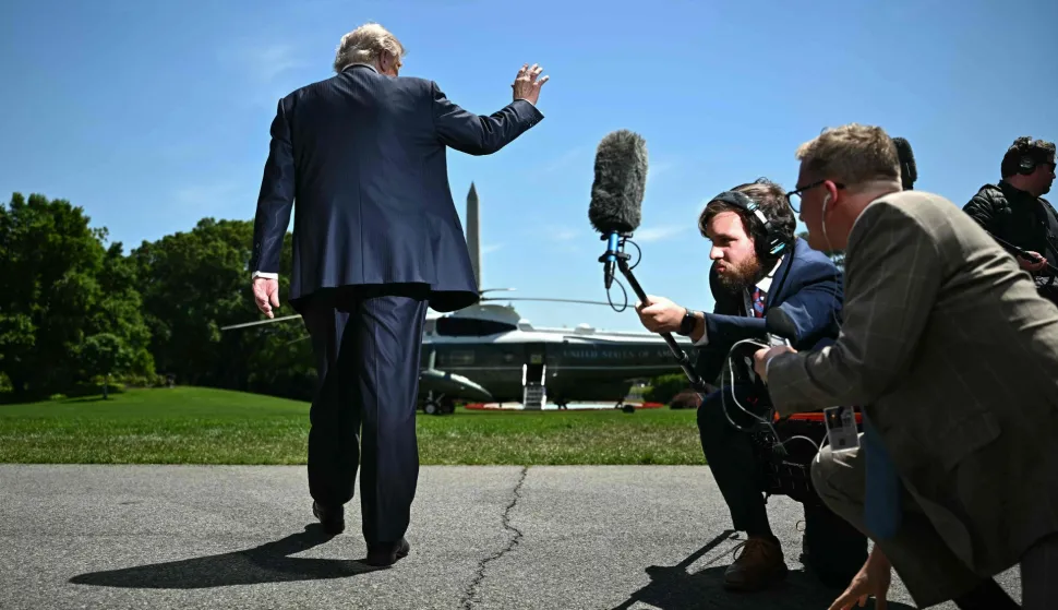 TOPSHOT - US President Donald Trump waves after speaking to the press as hewalks to board Marine One as he departs from the South Lawn of the White House in Washington, DC, on May 12, 2026. President Trump said Monday he was ready to discuss US arms sales to Taiwan during his visit this week to Beijing, as he suggested his personal chemistry with counterpart Xi Jinping would prevent a Chinese invasion of the island. Trump will bring along top US executives for a trip expected to focus heavily on the US president's hopes to ramp up trade. (Photo by Kent NISHIMURA/AFP)