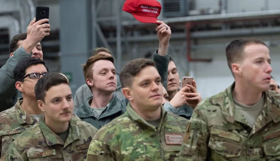 (FILES) A member of the US military holds up a "Make America Great Again" hat as US President Donald Trump and First Lady Melania Trump greet members of the US military during a stop at Ramstein Air Base in Germany, on December 27, 2018. Germany's defence minister on May 2, 2026, said the withdrawal of American troops from Germany had been expected and that Europe needed to do more to ensure its own security. The Pentagon on May 1, announced the withdrawal of about 5,000 troops from Germany within the next year, the latest rift in transatlantic ties over the Mideast war. (Photo by SAUL LOEB/AFP)