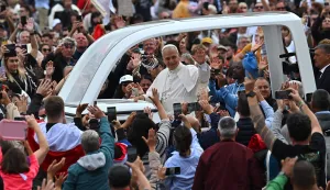 (FILES) Pope Leo XIV (C) waves to faithfull from the popemobile as he leaves St. Peter's Square at the Vatican after the Jubilee Mass for the missionary world and migrants, on October 5, 2025. On May 8, 2025, Robert Francis Prevost became the first North American pope under the name Leo XIV. In one year, he distinguished himself by a prudent and measured style, a strong social sensitivity and a firm desire to unify the Church. (Photo by Andreas SOLARO/AFP)