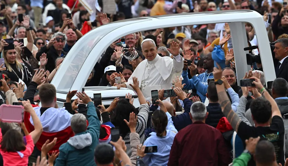 (FILES) Pope Leo XIV (C) waves to faithfull from the popemobile as he leaves St. Peter's Square at the Vatican after the Jubilee Mass for the missionary world and migrants, on October 5, 2025. On May 8, 2025, Robert Francis Prevost became the first North American pope under the name Leo XIV. In one year, he distinguished himself by a prudent and measured style, a strong social sensitivity and a firm desire to unify the Church. (Photo by Andreas SOLARO/AFP)