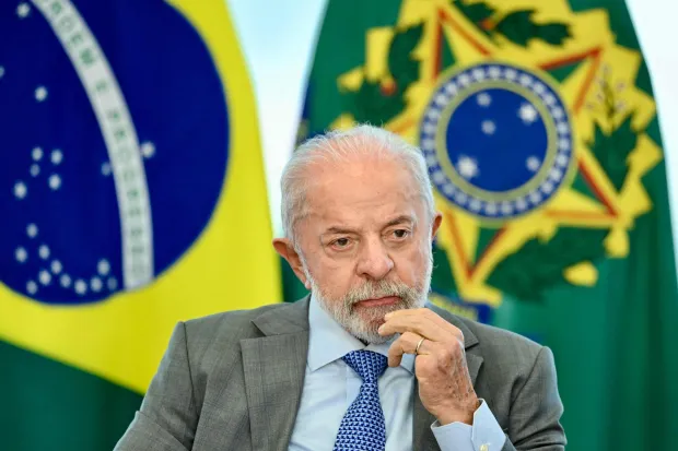 Brazil's President Luiz Inacio Lula da Silva looks on during the signing into law of a bill establishing a National Day of Remembrance for the Victims of COVID-19 in Brasilia on May 11, 2026. (Photo by Evaristo Sa/AFP)