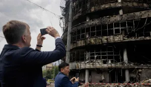 Members of diplomatic missions to Ukraine take pictures as they visit a heavily damaged shopping center following Russian strikes in Kyiv on May 25, 2026, amid the Russian invasion of Ukraine. (Photo by Tetiana DZHAFAROVA/AFP)
