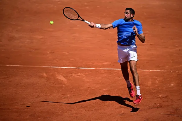 Croatia's Marin Cilic plays a forehand return to France's Moise Kouame during their men's singles match on day 3 of the French Open tennis tournament on Court Simonne-Mathieu at the Roland-Garros Complex in Paris on May 26, 2026. (Photo by JULIEN DE ROSA/AFP)