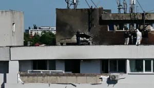 Police and forensic investigators stand on the rooftop as they examine the location of impact (C) over a damaged apartment after a Russian drone struck an apartment building in Galati, western Romania. A Russian drone wounded two people as it struck an apartment building in NATO-member Romania, its defence ministry said on May 29, 2026, the latest spillover from the four-year war into neighbouring states. (Photo by Daniel MIHAILESCU/AFP)