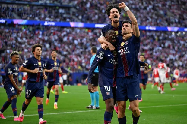 TOPSHOT - Paris Saint-Germain's French forward #10 Ousmane Dembele (L) celebrates after scoring his team's first goal after penalty with Paris Saint-Germain's Portuguese midfielder #17 Vitinha (C) and Paris Saint-Germain's Spanish midfielder #08 Fabian Ruiz during the UEFA Champions League final football match between Paris Saint-Germain (PSG) and Arsenal FC at the Puskas Arena in Budapest on May 30, 2026. (Photo by INA FASSBENDER/AFP)
