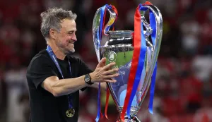 Paris Saint-Germain's Spanish head coach Luis Enrique touches the trophy after winning the UEFA Champions League final football match between Paris Saint-Germain (PSG) and Arsenal FC at the Puskas Arena in Budapest on May 30, 2026. Paris Saint-Germain beat Arsenal 4-3 on penalties to win their second consecutive Champions League title after a 1-1 draw in the final in Budapest on May 30. (Photo by FRANCK FIFE/AFP)