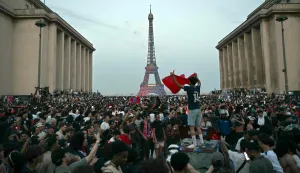 PSG supporters celebrate their team's win in the UEFA Champions League final between Paris Saint-Germain (PSG) and Arsenal FC played in Budapest, at Place du Trocadero opposite the Eiffel Tower in Paris on May 30, 2026. (Photo by LOU BENOIST/AFP)