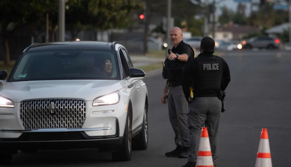 (FILES) Garden Grove police direct evacuees towards a shelter after a chemical leak from a large storage tank threatened residents in Garden Grove, California on May 22, 2026. Tens of thousands of people were ordered to leave their homes in California on May 22, after a huge chemical tank began leaking, with warnings it might blow up, sending toxic fumes over a heavily populated area. (Photo by Blake Fagan/AFP)