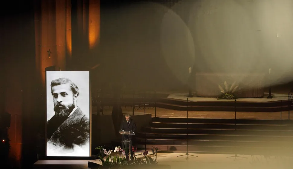 (FILES) A portrait of Spanish architect Antoni Gaudi is seen during a ceremony marking the 100th anniversary of the completion of the Sagrada Familia Basilica's Bernabe Tower, in Barcelona, on November 30, 2025. Antoni Gaudi was an extraordinary architect, creator of the Sagrada Familia and Park G?ell, and an icon of tourist Barcelona, but also a devout Catholic who is now ever closer to the beatification once envisioned for him by a group of admirers in Barcelona. Almost five million people entered the Sagrada Familia with a ticket last year, making it the most visited paid monument in Spain, while Gaud?s major works rank among the most in-demand attractions in the city. (Photo by Manaure QUINTERO/AFP)