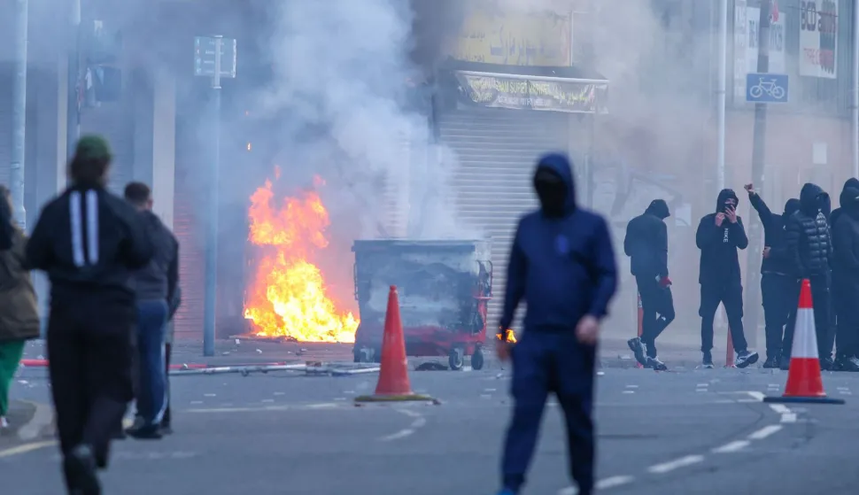 A building is set alight in the Sandy Row area of Belfast city centre, Northern Ireland, in the evening of June 9, 2026. Northern Ireland police appealed for calm Tuesday after a stabbing in Belfast allegedly by a Sudanese suspect and captured in a graphic video prompted calls for anti-immigration protests from UK far-right figures. (Photo by Paul Faith/AFP)
